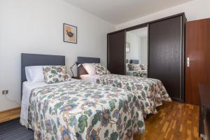 a hotel room with two beds and a closet at Casa Bruna in Labin