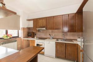 a kitchen with wooden cabinets and a sink at Casa Bruna in Labin