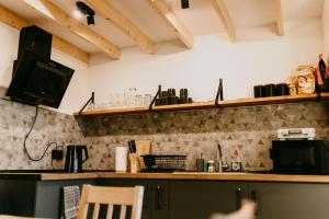 a kitchen with a counter top with a television and a counter top at Domki pod Kamionna in Laskowa