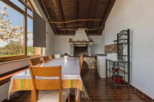 a dining room with a table and a fireplace at Casa Bruna in Labin