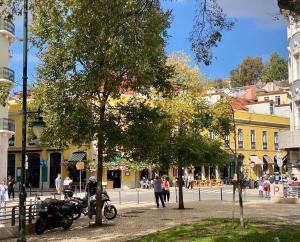 a motorcycle parked on a street in a city at Studios with Mezzanine Rua da Moeda in Lisbon