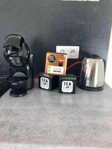 a counter top with a coffee maker and a toaster at Appartement Les Bons Vivants au coeur de Perrigny in Perrigny-sur-Loire