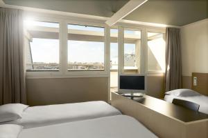 מיטה או מיטות בחדר ב-FIAP Paris