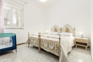 a white bedroom with a large bed in a room at Nature house nd in Carini