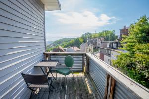 a balcony with a table and chairs and a view at The Peak Mt Washington - Large 2bd Apt w A View in Pittsburgh