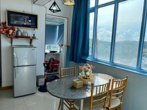 a kitchen with a table and a refrigerator at Duyên's Homestay - Căn hộ Sơn Thịnh 1 in Vung Tau