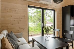 - un salon avec un canapé et une table dans l'établissement Mysig liten stuga perfekt för par eller liten familj, à Sälen