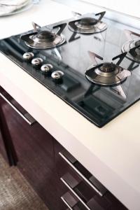 a stove top with four burners on a kitchen counter at ComeCasa Da Chiaretta in Milan