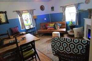 a living room with a couch and a table at Boho-Chic Retreat - Unit 3 in Bloomington