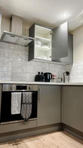 a kitchen with stainless steel cabinets and a stove at Abbey House in Horsham