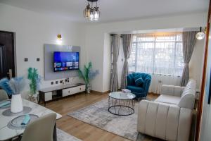 a living room with a couch and a table at Sana Home by Edmor Suites in Nairobi
