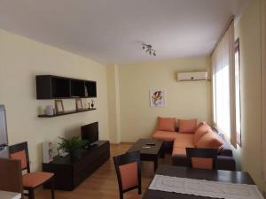 a living room with a couch and a table at The Terrace Apartment in Stara Zagora