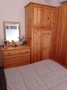 a bedroom with a bed and a dresser and a mirror at Appartamento - Pila Ciel Bleu - Il balcone sulle Alpi in Pila