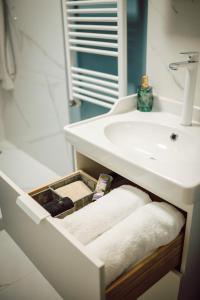 a bathroom with a sink and a drawer with towels at Apartament Ploiesti Central in Ploieşti