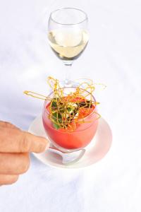 a person pointing at a glass of wine and a bowl of plants at Zanzibar Queen Hotel in Matemwe