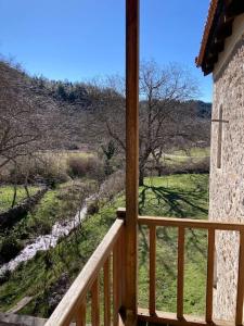 a balcony with a view of a field and trees at Παραδοσιακή Κατοικία στο Μαίναλο in Alonistaina