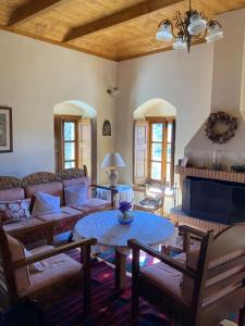 a living room with a couch and a table at Παραδοσιακή Κατοικία στο Μαίναλο in Alonistaina