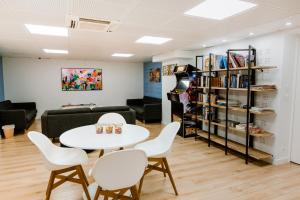 a living room with a table and chairs and a couch at FIAP Paris in Paris