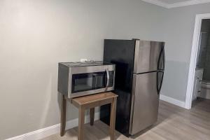 a microwave on a table next to a refrigerator at Marco Island Lakeside Inn in Marco Island