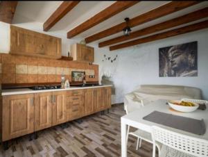 a kitchen with wooden cabinets and a white table at Neptuno OceanFront in Telde