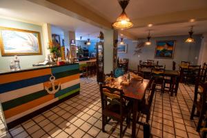 Odoiá Maragogi Restaurante e Estalagem في ماراغوغي: مطعم بطاولات وكراسي وكاونتر