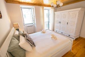 ein Schlafzimmer mit einem großen weißen Bett in einem Zimmer in der Unterkunft Eira das Lages in Seia