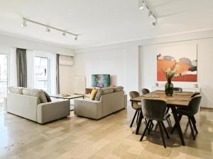 a living room with a table and chairs at Dimitsanas by Verde Apartments in Athens
