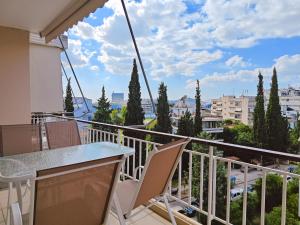 a balcony with a table and chairs and a view at Dimitsanas by Verde Apartments in Athens
