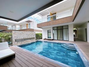a swimming pool in the middle of a house at Phoenix Pool Villa Cam Ranh in Cam Ranh