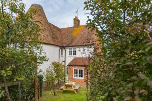 a house with a picnic table in front of it at Hearts Delight Cottage by Bloom Stays in Bridge