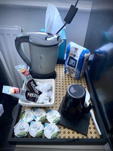 a drawer in a refrigerator filled with food and a coffee maker at Room in apartment home-Stretford in Manchester