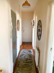 a hallway with a rug on the floor next to a door at Room in apartment home-Stretford in Manchester