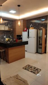 a kitchen with white appliances and a counter top at Casa 108 in Guaibim
