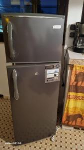 a metal refrigerator is sitting in a kitchen at Villa Les Pieux in Somone