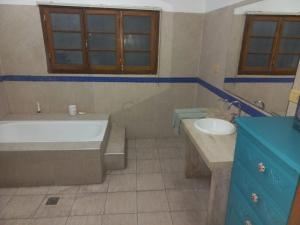 a bathroom with a tub and a sink at CÉNTRICO in Santiago del Estero +12 photos