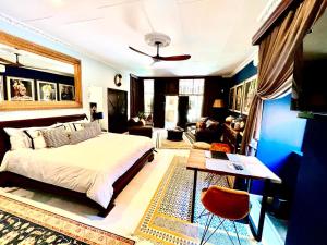 a bedroom with a bed and a living room at Forty 4 On Hoog in Polokwane
