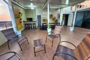 a lobby with chairs and tables in a building at Apartamento confortable in Ciudad del Este