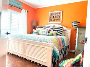 a bedroom with a bed with a happy happy sign on it at Riverfront condo downtown newbraunfels in New Braunfels