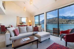 a living room with a couch and a table at Absolute Lakeside in Queenstown