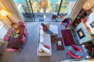 a view of a living room with a couch and chairs at Absolute Lakeside in Queenstown