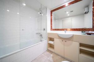 a bathroom with a sink and a shower and a mirror at Absolute Lakeside in Queenstown +15 photos