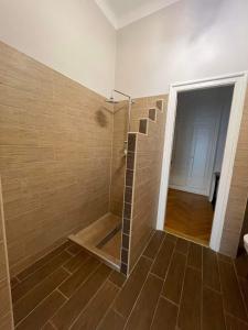a bathroom with a shower with a glass door at Marietta in Debrecen