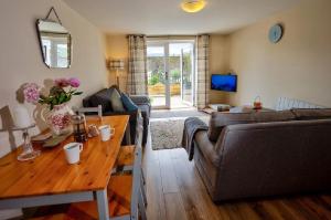 a living room with a couch and a table at Howgills Apartments in Sedbergh