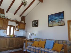 a living room with a couch and a kitchen at Dream House On The Beach in Figueira da Foz