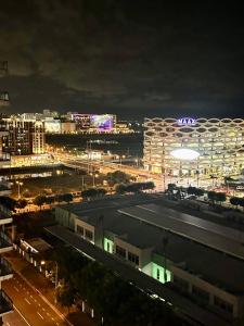 a view of a city at night with lights at Sea Residences - Rylee’s Perfect Place in Manila