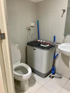 a bathroom with a toilet and a sink at Sea Residences - Rylee’s Perfect Place in Manila