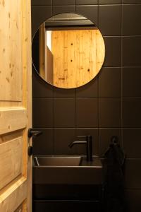 a bathroom with a sink and a mirror at bergfried - Designwohnung mit Weitblick in Fulpmes