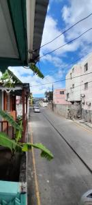 a view of an empty street from a bus at Comfort BNB in Basse Terre Town