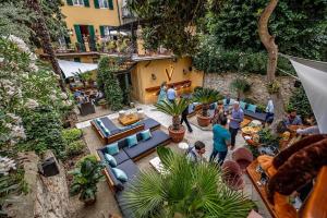 a group of people standing in a courtyard with furniture at Hotel Ungherese Small Luxury Hotel in Florence