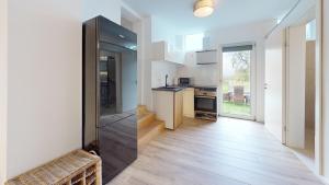 a kitchen with white walls and wooden floors at Frisch sanierte Ferienwohnung in Altensteig +4 photos